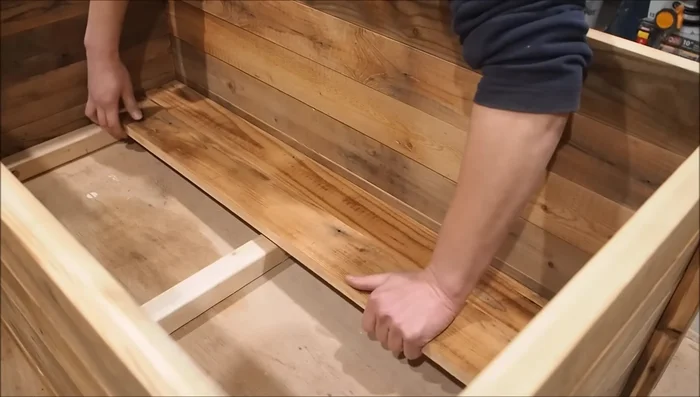 Install floorboards, securing them to the 2x2 base using a nail gun.