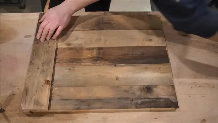 Assemble each wall using five boards, aligning them with the spacer and securing with brad nails.