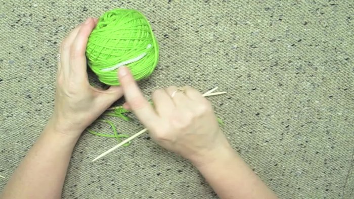 Prepare your yarn by stringing beads onto it and winding it into a ball, keeping most beads away from the working area.