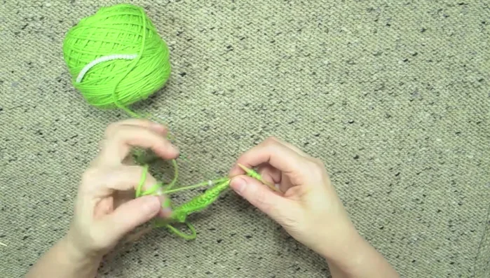 Knit the next stitch. The bead is now incorporated into the work, on the back side.