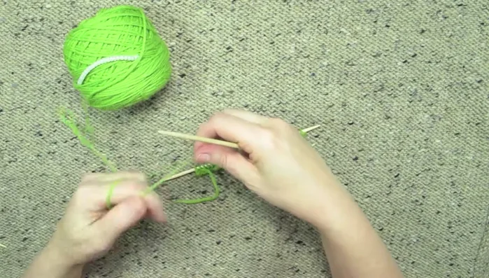 Turn your work and begin the beaded row. Follow your chart to determine the bead placement. The example uses a pattern of 'knit three, place a bead, repeat'.