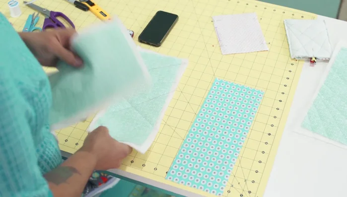 Trim excess batting: Once quilted, trim excess batting.