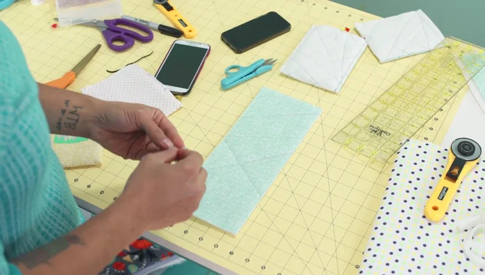 Trim excess batting: Once quilted, trim excess batting.