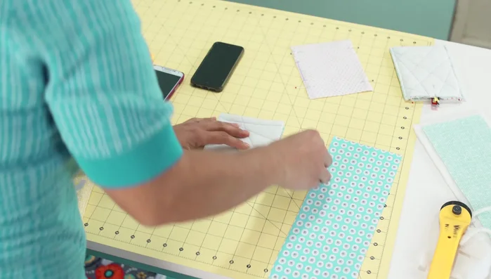 Sew the outer fabric: Fold the quilted outer fabric in half with pretty sides touching. Stitch a 1/4 inch seam allowance along three sides, leaving one side open.