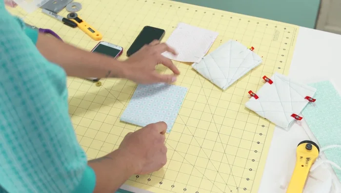 Sew the lining fabric: Fold the lining fabric in half with pretty sides touching. Stitch a 1/4 inch seam allowance along three sides, leaving a 2 1/2 inch opening on one side.