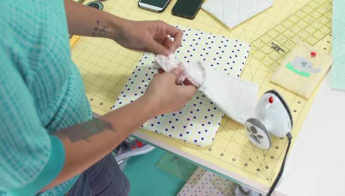 Attach button: Hand-stitch the button to the front of the cozy, ensuring it's positioned correctly for closure.