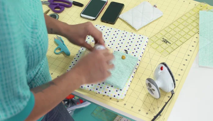 Attach button: Hand-stitch the button to the front of the cozy, ensuring it's positioned correctly for closure.