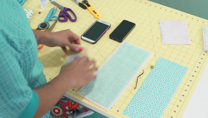 Prepare fabric and batting: Cut two pieces of fabric (outer and lining) measuring 4 1/2 inches by 11 3/4 inches. Cut one piece of batting slightly larger.