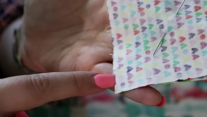 Sew around all four sides of the layered squares with a 1/8-inch seam allowance. Leave a small gap (about half an inch) along one side for turning.