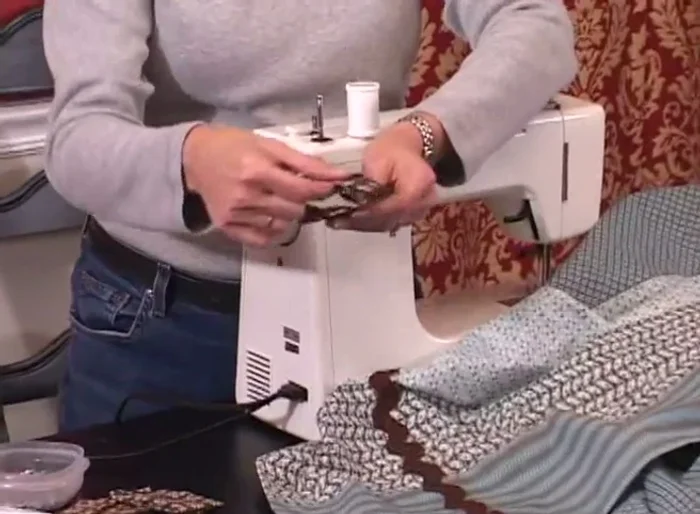 Sew a line along the bottom edge of the tab to secure it and ensure it hangs flat.