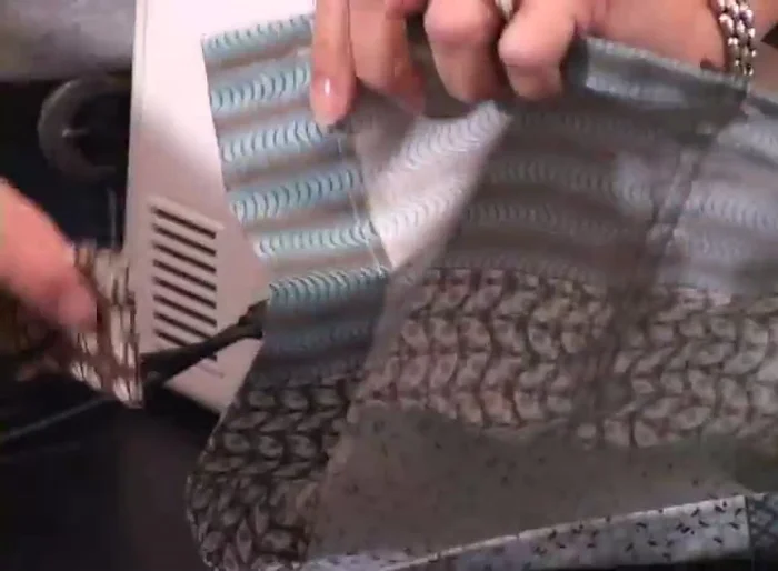 Sew a line along the bottom edge of the tab to secure it and ensure it hangs flat.