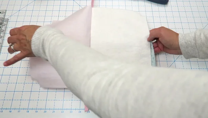 Fold the bag right sides together, zipper teeth facing the lining. Clip in place and sew around the edges, leaving a 4-inch opening in the lining.