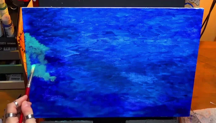 Using a stiff bristle brush to add turquoise, creating a mix of harsh and soft edges.