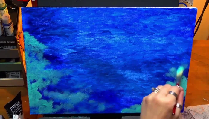 Using a stiff bristle brush to add turquoise, creating a mix of harsh and soft edges.
