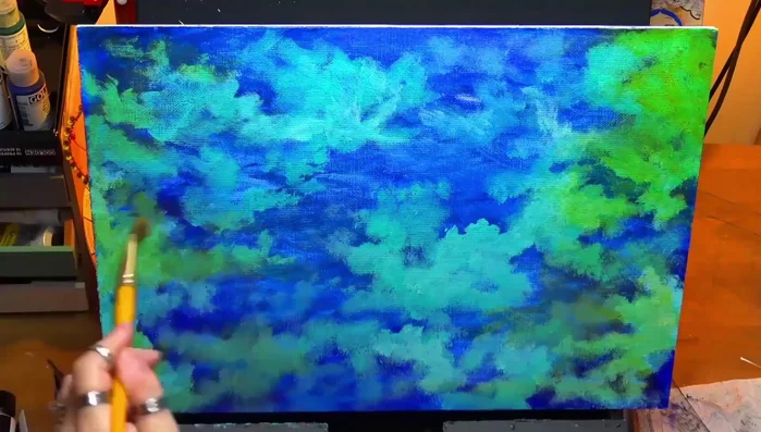 Applying another thin glaze tinted with a tiny bit of blue to further refine the background.