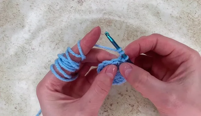 Work 1 double crochet into the next stitch, then 2 double crochet stitches into the next stitch, followed by another 2 double crochet stitches and 2 more double crochet stitches.