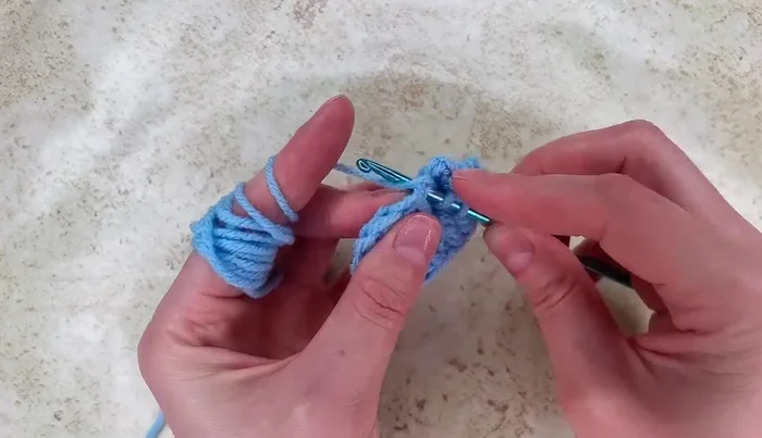 Work 1 double crochet into the next stitch, then 2 double crochet stitches into the next stitch, followed by another 2 double crochet stitches and 2 more double crochet stitches.