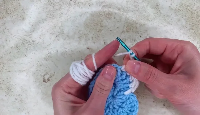 Chain two, work one double crochet, then work half double crochet, single crochet, and double crochet into the next stitches, followed by treble, double treble, and treble again. Repeat the pattern for the remaining stitches.