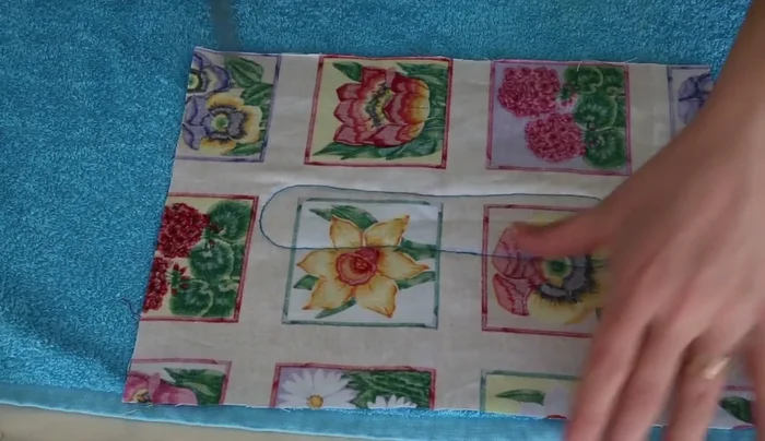 Fold the seam allowance inward and stitch it down, securing the raw edges.