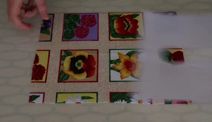 Position the traced fabric onto the right side of a towel, centering the traced shape about 10-15cm from the edge.