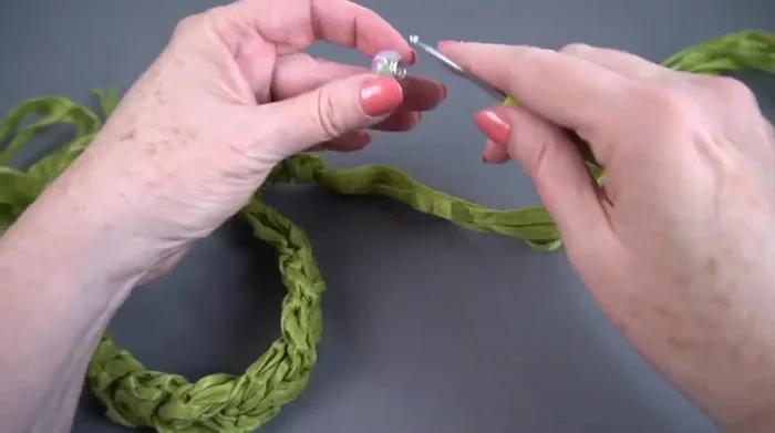 Thread the remaining six strands through the bead from the opposite side.