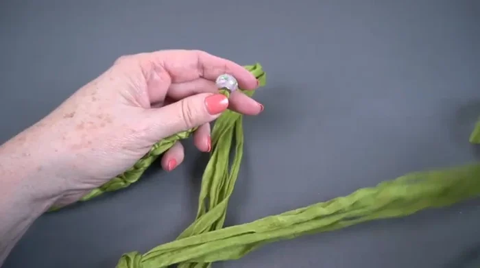 Thread the remaining six strands through the bead from the opposite side.