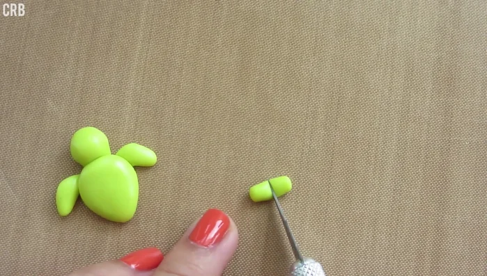 Create two smaller teardrop shapes for the back flippers and attach them to the shell.