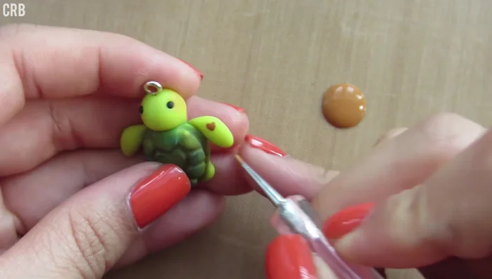 Paint brown spots and hearts on the flippers and optionally on the head using a dotting tool.