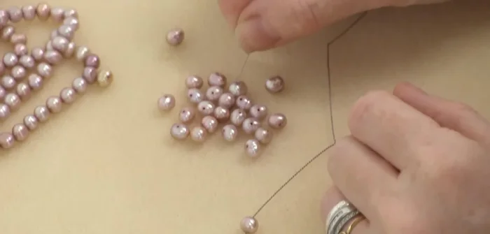 Continue knotting: Repeat steps 5 and 6 until all pearls are strung and knotted.