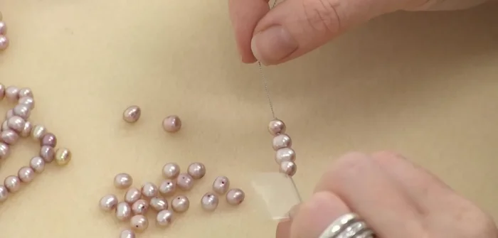 Continue knotting: Repeat steps 5 and 6 until all pearls are strung and knotted.