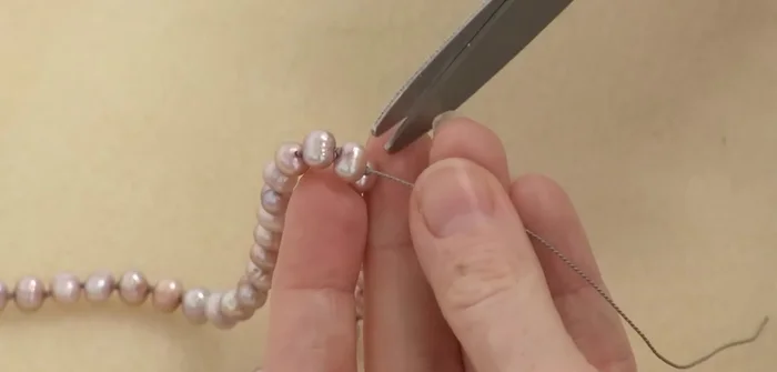 Trim and secure the ends: Trim the excess silk and apply a small amount of GS hypo cement to the knots to prevent unraveling.