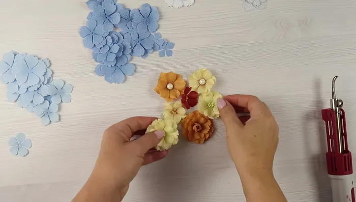 Shape the flowers using a mini iron with a curved smooth tip. Go from the top of the petal towards the center on one side, flip, and repeat on the other side.