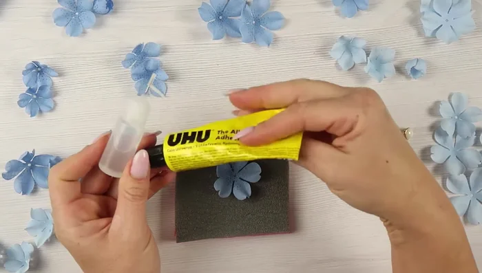 Add stamens or buttons to the center of the flower.