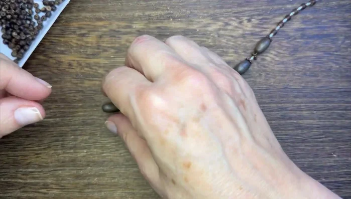 Add a trio of metal charms as a focal point, attaching them with double jump rings.