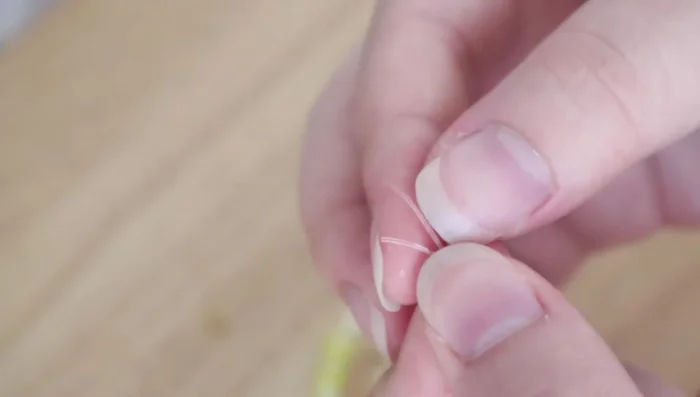 String beads onto the cord.