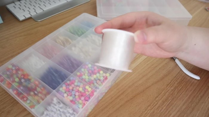 Gather materials: Stretch cord, beads, crimp beads, crimp bead covers, jump rings, pliers.