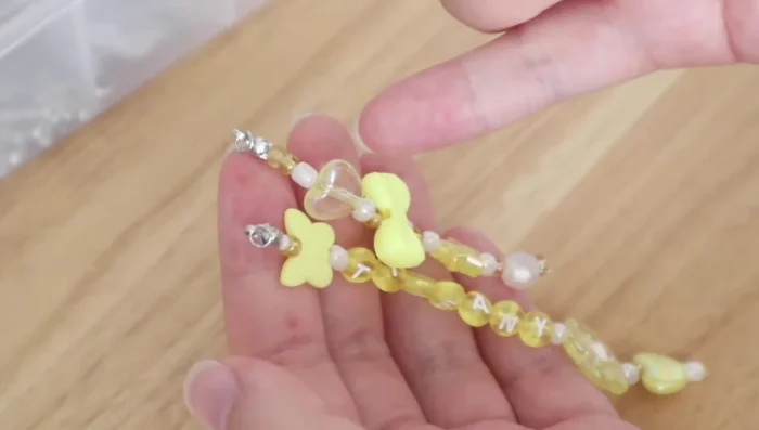 Attach both keychains to a lobster clasp using a larger jump ring.