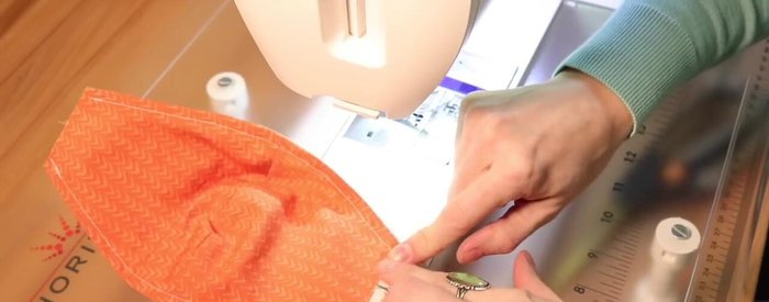 Fold and press the edges where the elastic will be attached.