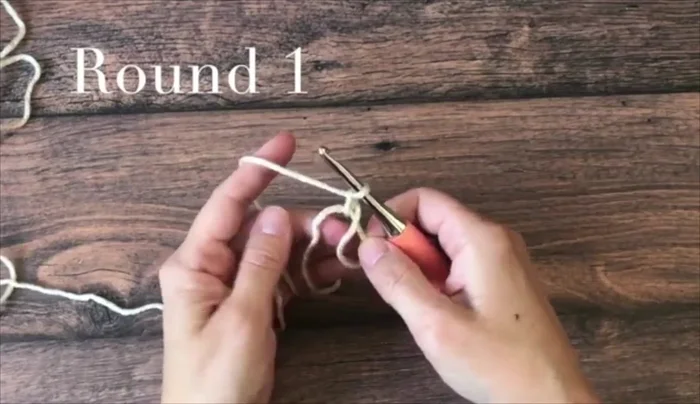 Round 1: Chain 2, then work 12 double crochets into the magic circle, working over both strands of the loop. Join with a slip stitch.