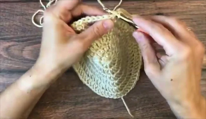 Continue working in the round with one double crochet in each stitch until the hat reaches the desired height.