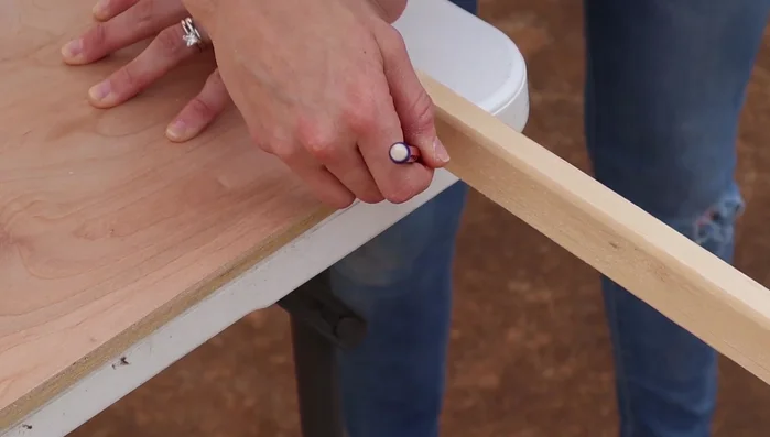 Determine sign size, cut birch wood, and create a frame using 1x2s. Mark and cut the 1x2s precisely using a miter saw, ensuring accurate measurements.