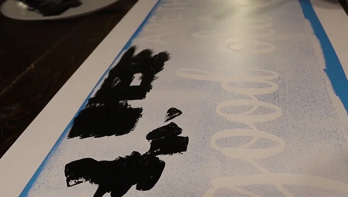 Apply black paint using a dabbing motion, avoiding globs to prevent bleeding. Let it dry completely.