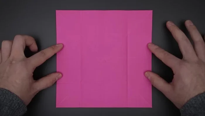 Close the paper using the four diagonal folds. Bring the four sides to the middle.