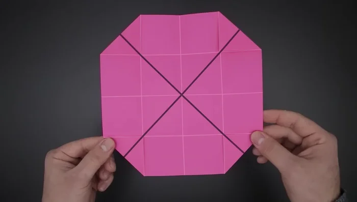 Close the paper using the four diagonal folds. Bring the four sides to the middle.