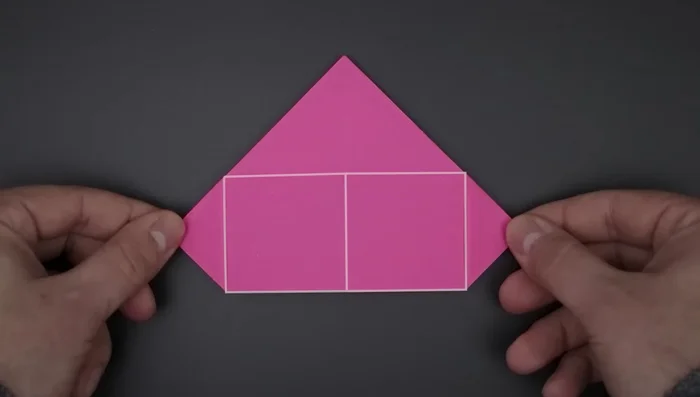 Bring down the top triangles, unfold, and flatten to create flaps.