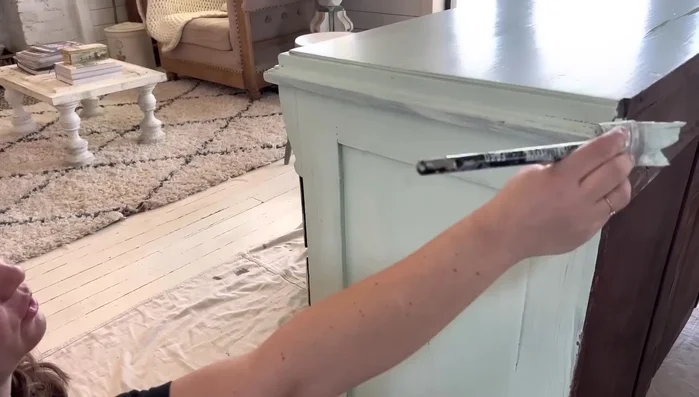 Apply clear wax to blend and control dark wax application (optional)