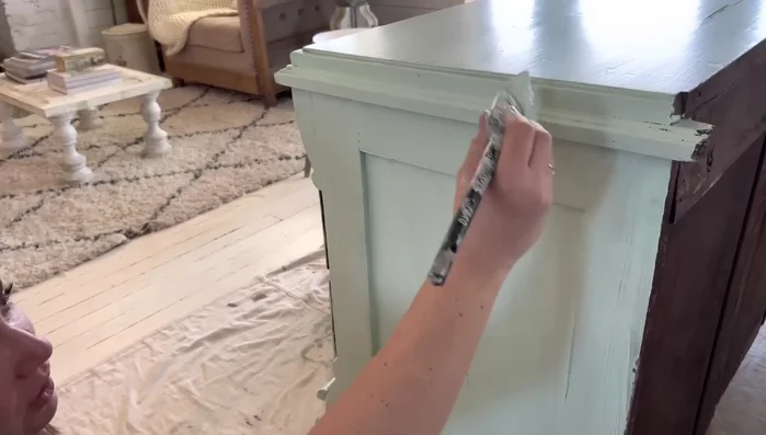 Apply clear wax to blend and control dark wax application (optional)