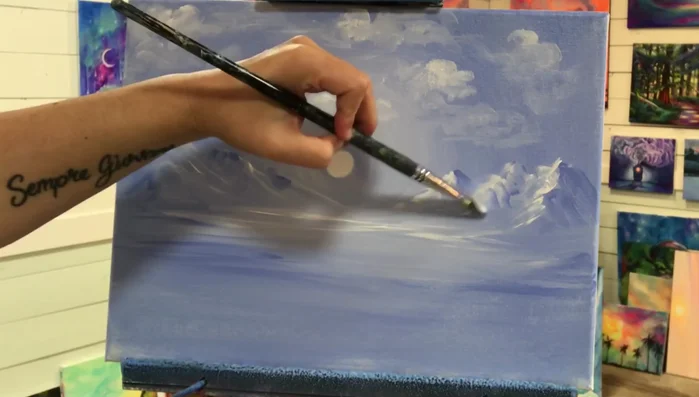 Layer with titanium white. Apply thin layers of titanium white without water to blend smoothly with the wet underpainting, creating a soft, hazy effect.