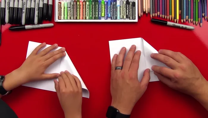 Fold the bottom edges up, aligning them with the center crease.