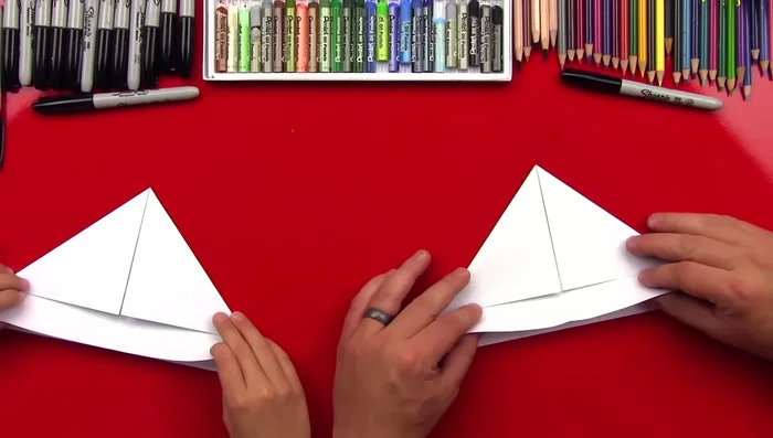 Fold the bottom edges up, aligning them with the center crease.